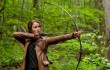 Jennifer Lawrence wields her weapon of choice in The Hunger Games.