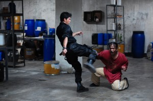 FILM Iko Uwais deals a kick to one of many bad guys in The Raid: Redemption.