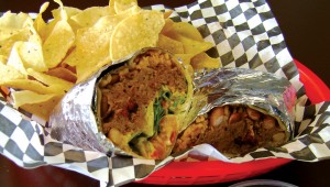You’ll need a knife and fork to get at Mojo’s pulled pork burrito. Bonnie Mays