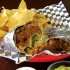 You’ll need a knife and fork to get at Mojo’s pulled pork burrito. Bonnie Mays