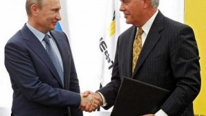 ExxonMobil CEO Rex Tillerson (right) shakes hands with Russian President Vladimir Putin