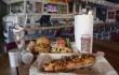 The Winnebago bar provides a quirky backdrop for some of Twisted Root’s signature items, including the Dirk Diggler Dog (front). Lee Chastain