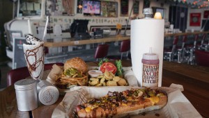 The Winnebago bar provides a quirky backdrop for some of Twisted Root’s signature items, including the Dirk Diggler Dog (front). Lee Chastain