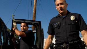 Michael Peña and Jake Gyllenhaal show off a gold-plated AK-47 in "End of Watch".