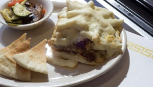 Mixed veggies and pita bread accompany a serving of pastitsio at The Vine. Chase Martinez