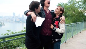 Logan Lerman, Ezra Miller, and Emma Watson celebrate a high-school triumph in The Perks of Being a Wallflower.