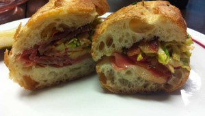 The cherry-wood smoked bacon, prosciutto, and Eagle Mountain gouda sandwich is available at Magnolia Cheese Company.