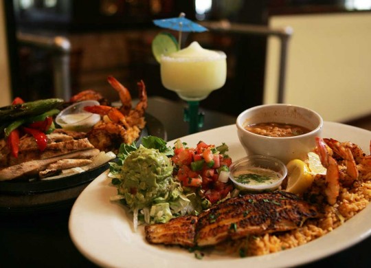 #div4 Don Mario’s serves up their Ultimate Fajitas (left) and a platter of catfish and shrimp. Lee Chastain