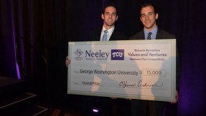 Herman, left, and Fox couldn’t fit their presentation check into carry-on luggage, but the proceeds will fit nicely into their business. Photo by B.J. Lacasse, courtesy TCU
