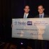 Herman, left, and Fox couldn’t fit their presentation check into carry-on luggage, but the proceeds will fit nicely into their business. Photo by B.J. Lacasse, courtesy TCU