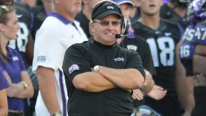 Coach Gary Patterson leads TCU out at Cowboys Stadium, Sat.