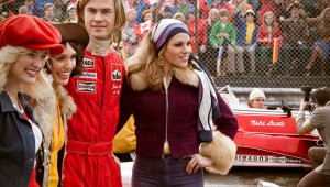 Chris Hemsworth hangs out with Formula One groupies while Daniel Brühl looks on in Rush.