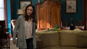 Who's on the sofa behind Rose Byrne in Insidious: Chapter 2?