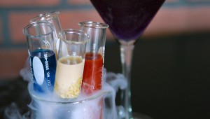 The Lab Rack, a flight of shots, is served in a smoking beaker.