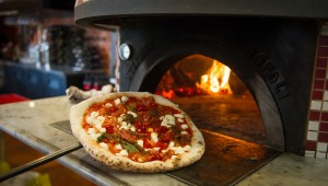The pies come straight from Cane Rosso’s 900-degree brick oven. Brian Hutson