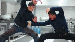 Iko Uwais and Cecep Arif Rahman go at each other with curved blades in a restaurant kitchen in The Raid 2.