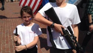 THIS PICTURE OF "OPEN CARRY TEXAS" CHILDREN CARRYING GUNS AT MAIN STREET ARTS FESTIVAL WAS PUBLISHED ON THE MERICANS AGAINST THE TEA PARTY WEB SITE.