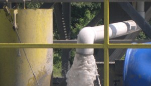 Flowback water flows fiercely at a gas rig near Everman.