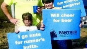 TRINITY RIVER VISION SPOKESMAN MATT OLIVER (BACK LEFT) AND J.D. GRANGER (BACK RIGHT) AND GRANGER'S CHILDREN CHEER ON RUNNERS AT THE COWTOWN MARATHON EARLIER THIS YEAR.