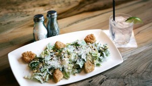 Along with a Bee’s Knees signature cocktail, R Bar & Grill offers a caesar salad with fried green tomatoes. Lee Chastain