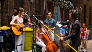 Backed by session musicians and neighborhood kids, Keira Knightley and Mark Ruffalo prepare to record outdoors in Begin Again.