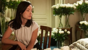 Olivia Wilde finds a lot of white roses in her hotel room in Third Person.