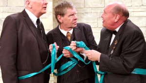 Jim Covault, Cliff Stephens, and David Coffee wind up entangled in a garden hose as part of their escape plot in Heroes. See Friday.