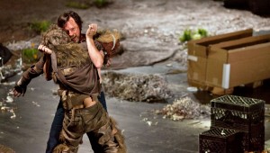 Dog Days’ James Bobick, as the father Howard, hoists Josh Kelly, portraying the dog Prince, to his feet in an effort to make him stand and reclaim his humanity in second act of the opera. Photo courtesy: Peak Performances at Montclair State University (NJ) In association with Beth Morrison Projects