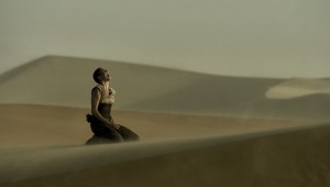 Charlize Theron curses to the sky in "Mad Max: Fury Road."
