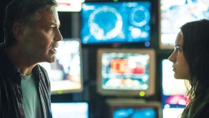 In front of monitors forecasting doom, George Clooney and Britt Robertson have it out in Tomorrowland.