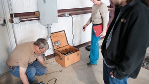 Members of the SMU earthquake research team install a broadband seismicity monitor inside a storage building in the Reno/Azle area. Photo by Hillsman Jackman.