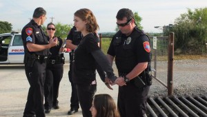 A MEMBER OF BLACKLAND PRAIRIE RISING TIDE IS ARRESTED THIS MORNING IN DENTON (Photo courtesy of Blackland Prairie Rising Tide)