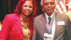 Genma Holmes poses with Congressional Gold Medal recipient Mark McCann Sr., one of the first black Marines. Holmes profiled McCann in the magazine she produced. Courtesy of Genma Holmes.