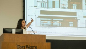Sasha Camacho points to designs for a Hooters slated for downtown Fort Worth. Photo by Brian Hutson.