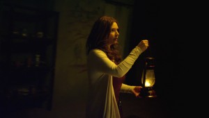 Brigid Brannagh searches the darkness outside her Moldovan house in "They're Watching."