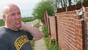 The wall behind Jim Strachan’s house is falling apart and could cost tens of thousands of dollars to replace. Photo by Jeff Prince.