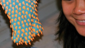 Dan Lam uses a cake frosting squirter to apply the tiny horns to her sculptures. Photo by Jeff Prince.