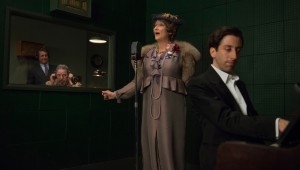 Meryl Streep cuts a recording while Simon Helberg (foreground) accompanies her in "Florence Foster Jenkins."
