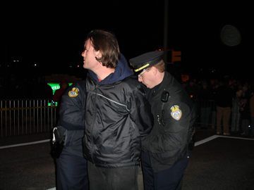 Police arrest Langley at an anti-death-penalty rally.