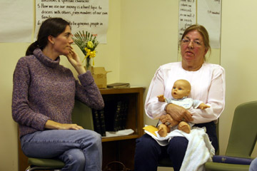 Stumph chats with Peggy Kandies, who cradles a baby doll in memory of her son on death row.