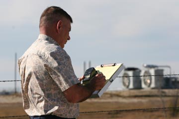 Fors checks the sound levels at a gas well compressor station near his neighborhood.