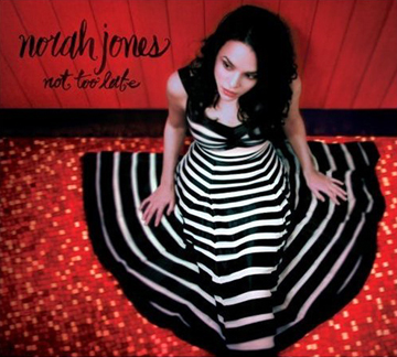 Norah Jones has done a lot to quash the expectations established by her first album, 2002’s Come Away With Me. She has remained active, upping her accessibility — and quiet ubiquity — through varied and fruitful collaborations with everyone from Ryan Adams and Outkast to Ray Charles, Willie Nelson, and Bonnie Raitt. Her side projects included a brief stint with the classic country group The Little Willies, and an album with the Peter Mallick Group. All of this is an attempt to ready listeners for her third solo album, Not Too Late. While the album finds Jones reconnecting with guitarist and songwriter Jesse Harris, whose work fueled the success of Come Away With Me, she otherwise sticks to her core band. Not only has she abandoned the aid of the venerable guest musicians who lent their hands to her early work, but Jones also wrote or co-wrote every number on Not Too Late, no longer relying on smartly chosen cover songs. So does this step out make for a better album? Noticeably missing are the freshness from her first album and the slow, chugging folk engine that powered its successor, Feels Like Home. But Not Too Late finds cohesion in its pervasive slowness and quiet desperation. Jones’ jazz purist critics will find little trace of what they consider authentic jazz, with “Sinkin’ Soon” the only song to hearken to the ’30s, jazz’ purported Golden Age. The track, though, especially in its lyrics, has more in common with Tom Waits, whom Jones covered on Feels Like Home. It fits in well with songs like “My Dear Country,” Jones’ most overt political statement. But overall she subtly weaves together musings on the dour direction the world is taking with hopefulness about love and companionship. Not Too Late is as soothing as Jones’ music can get, but ultimately it is not as inventive or commanding as her previous work. No, it’s “not too late to change,” but it may be too early to settle on the first change that presents itself.