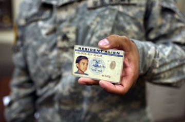 A U.S. Army recruiter, now a citizen, shows his old ID card.