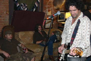 Kord Murphy and Michael Maftea listen while Jordan Mycoskie rehearses with his band.
