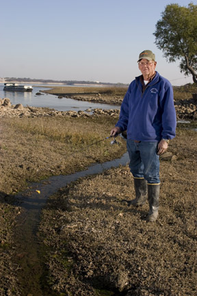 Don Long drops his fishing line in a rivulet that used to be part of Benbrook Lake. Photo by Naomi Vaughan.