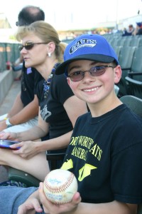 Trenton Lieske shows off his latest Cats souvenir.