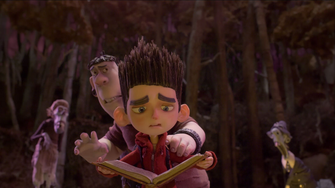 School bully Alvin cowers behind Norman as he tries to read the incantation that’ll stave off the walking dead in ParaNorman.