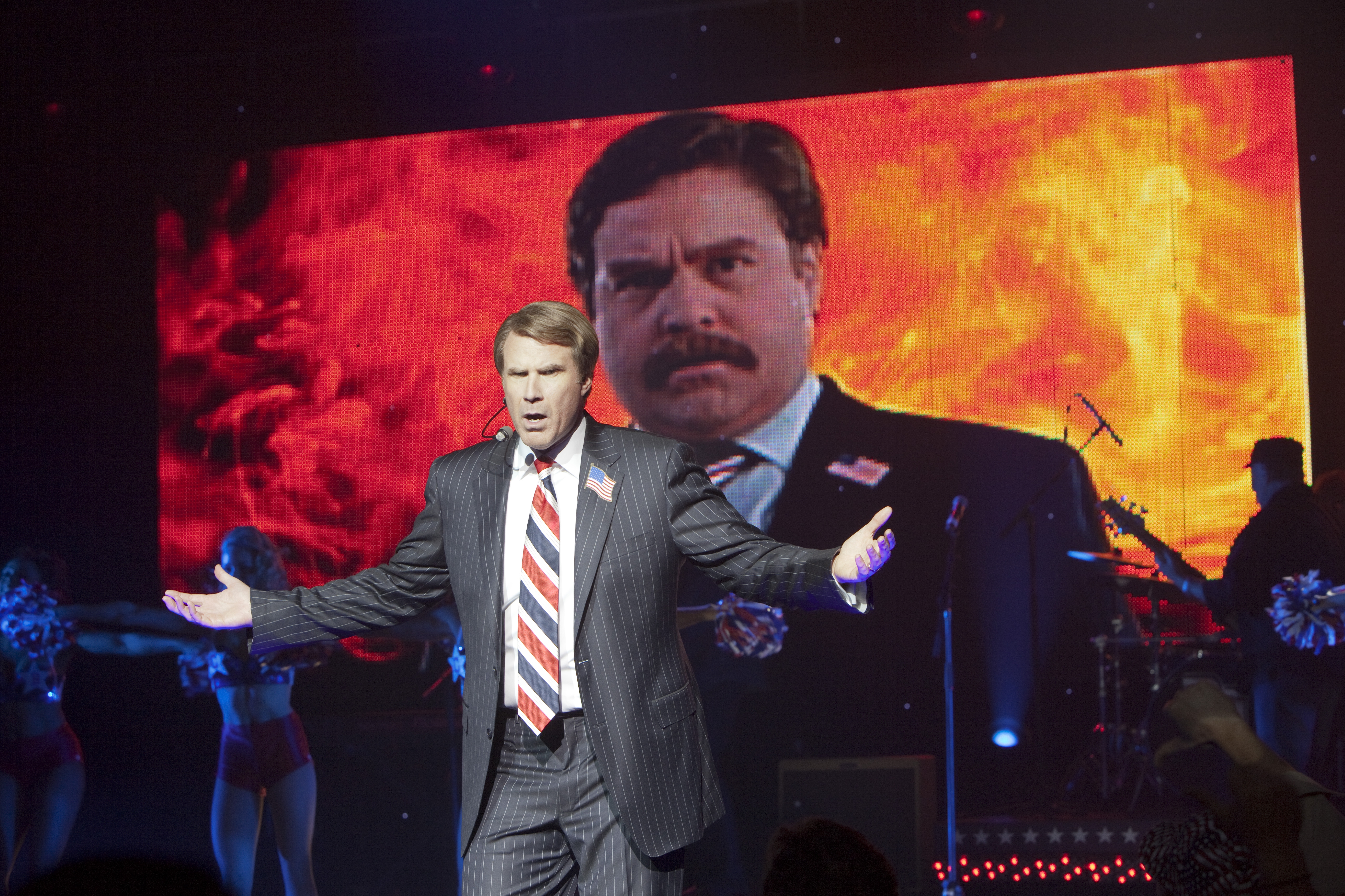 Will Ferrell poses in front of a negative ad aimed at Zach Galifianakis in "The Campaign."