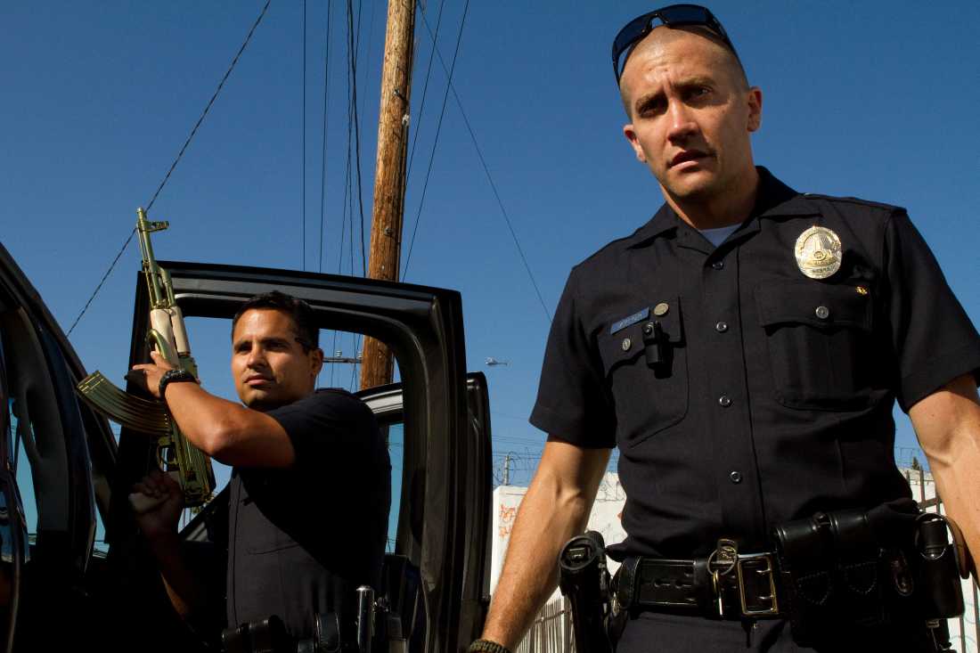 Michael Peña and Jake Gyllenhaal show off a gold-plated AK-47 in "End of Watch".