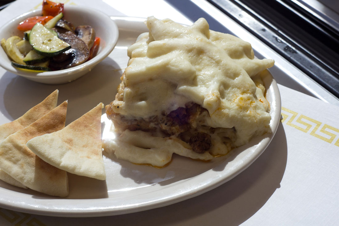 Mixed veggies and pita bread accompany a serving of pastitsio at The Vine. Chase Martinez